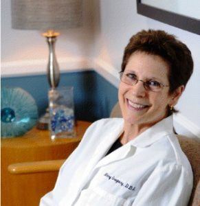 Dr. Mary Gregory, dentist in Arlington, Virginia, sitting near decorative table